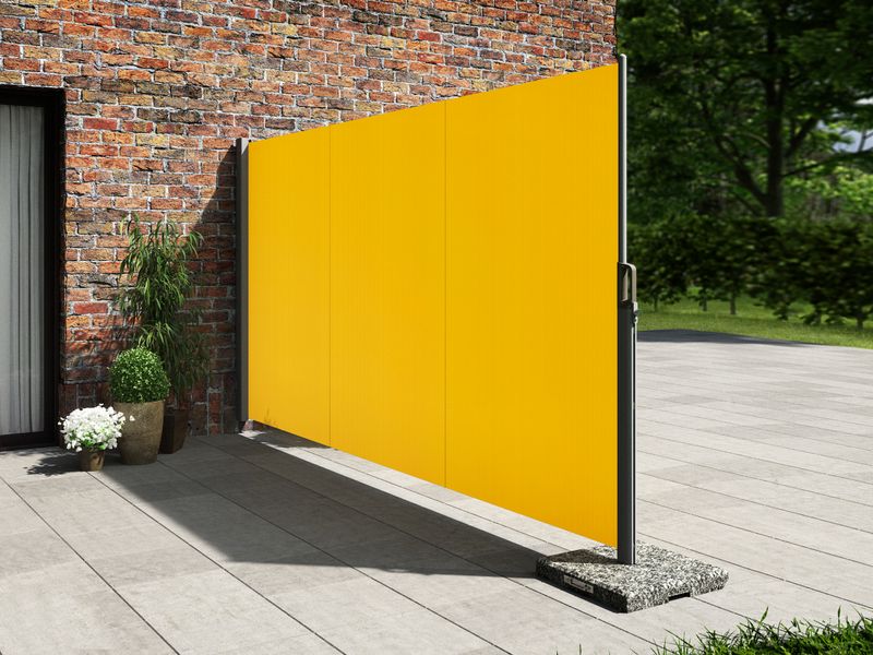 A yellow privacy Mobilfix is attached to a house wall