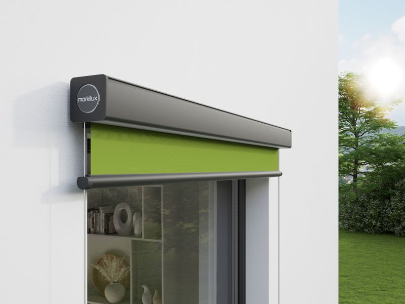 Detail view of vertical cassette awning markilux 710: gray frame, green fabric cover, wall mounted.