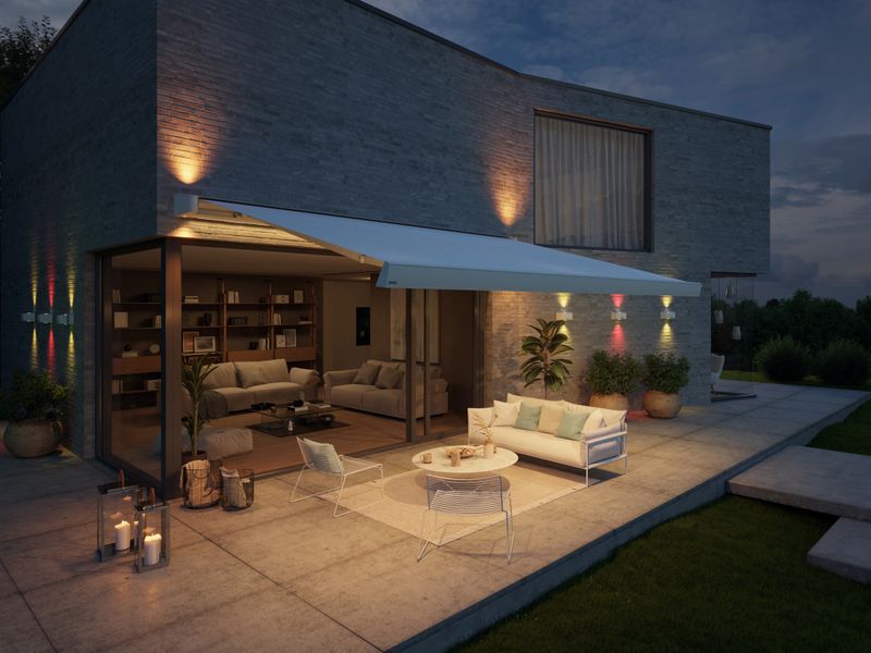 markilux MX-4 in white with white cloth and colorful lighting in the awning and on the house wall