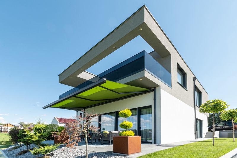 reference markilux mx-1 compact: awning with green fabric cover on modern design house